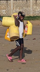 smiley child collecting water